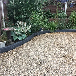 A garden with gravel and plants in it.