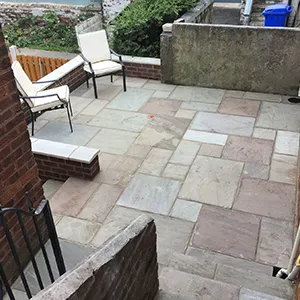 A patio with chairs and a fire pit.