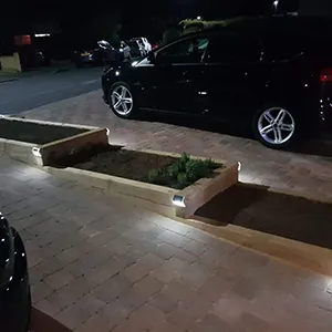 a black car parked in a parking lot at night