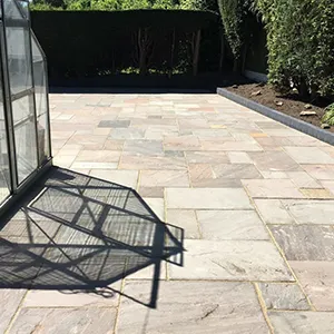 a metal cage sitting on top of a stone walkway