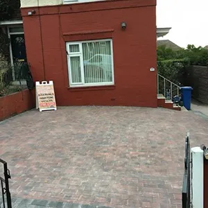 a red brick building with a sign in front of it